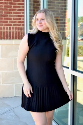 Black sleeveless pleated dress