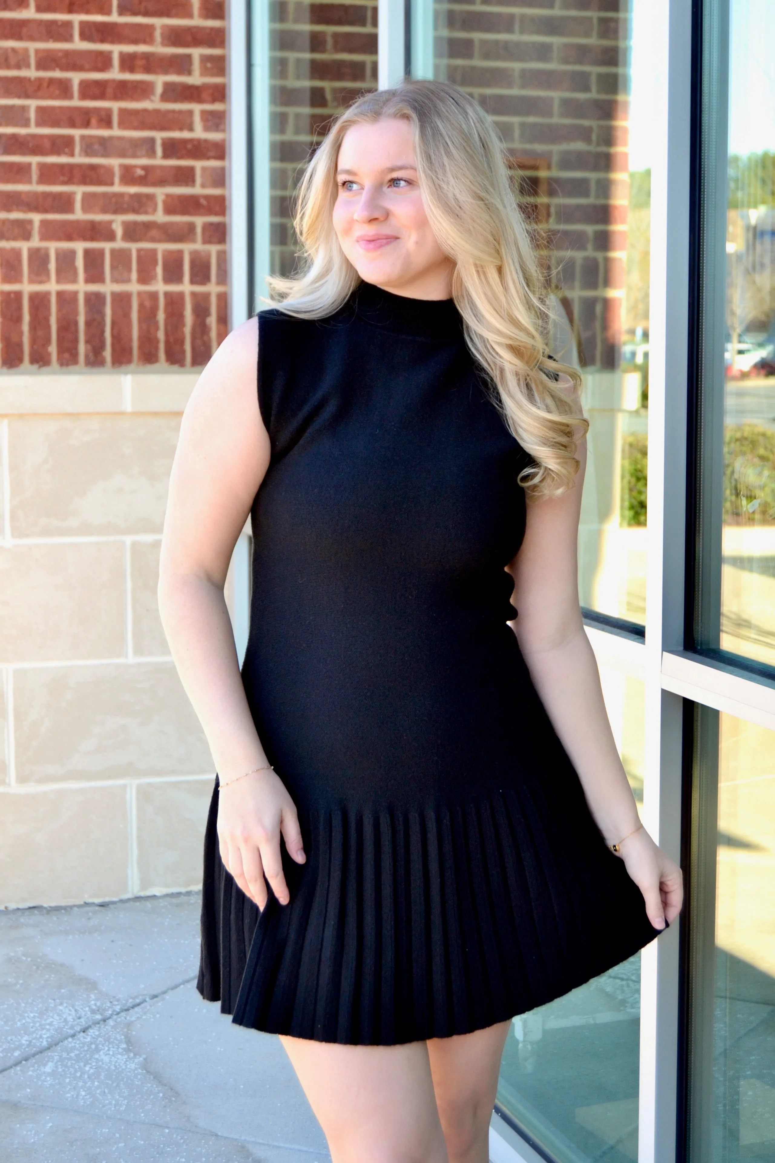 Black sleeveless pleated dress